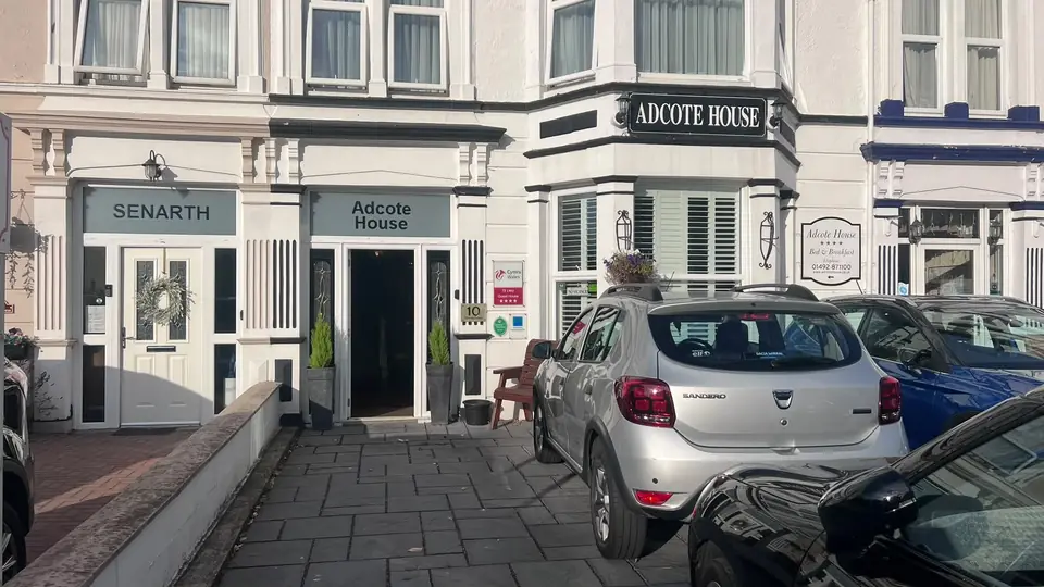 Real photograph of the GOAT House frontage on its Llandudno terrace, with the Great Orme in the background (taken before the rebrand)
