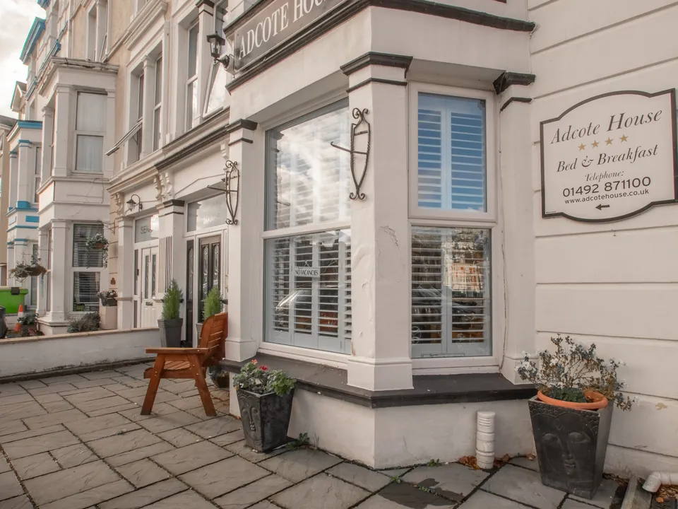 The front of the house on Deganwy Avenue, with its bay window, shutters and the old Adcote House sign