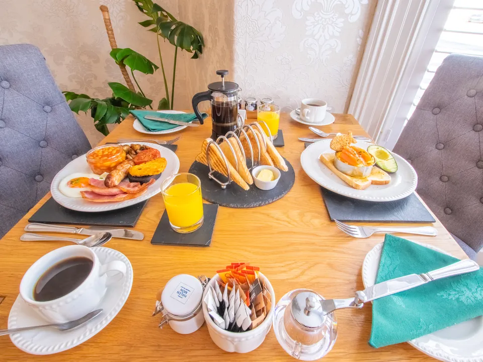 Breakfast for two: a full Welsh and eggs on toast, with toast, coffee and orange juice