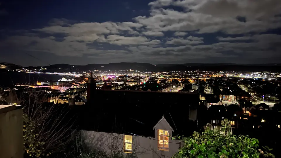 Llandudno at night from high on the Great Orme, with the town lights curving round the bay