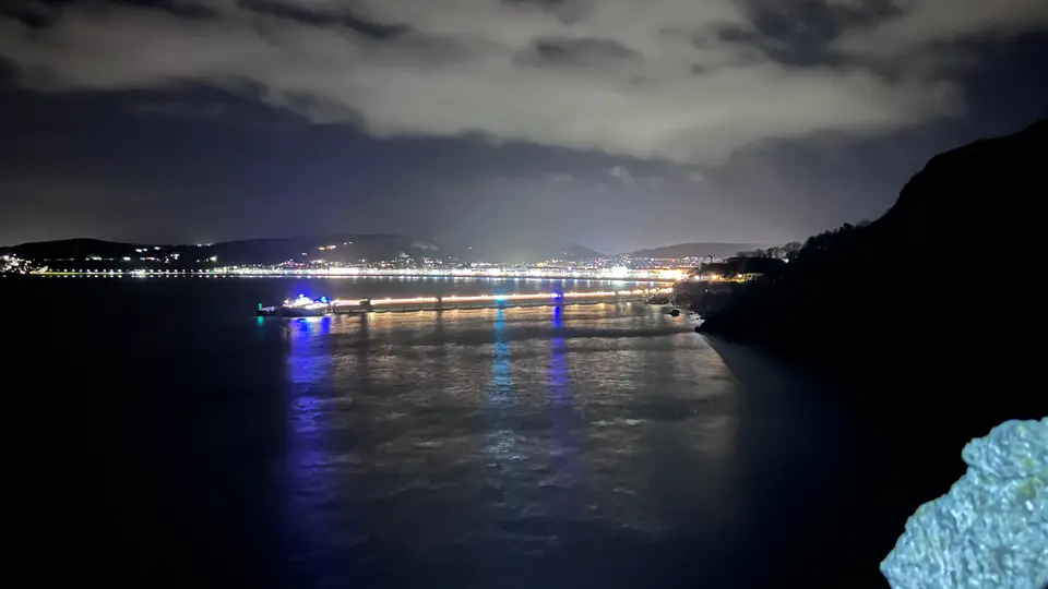 Llandudno pier lit up at night, seen from the Great Orme