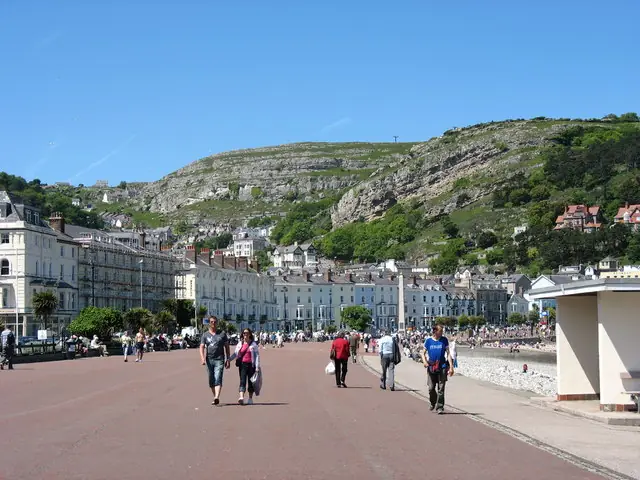 Real photograph of Llandudno's Victorian promenade with the Great Orme rising behind it