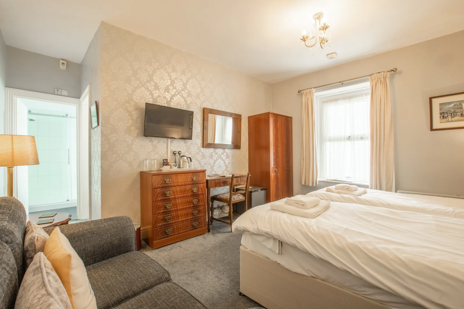 Beaumaris, Room 1: the room from the sofa, with the wardrobe, writing table and TV, and the en-suite door open