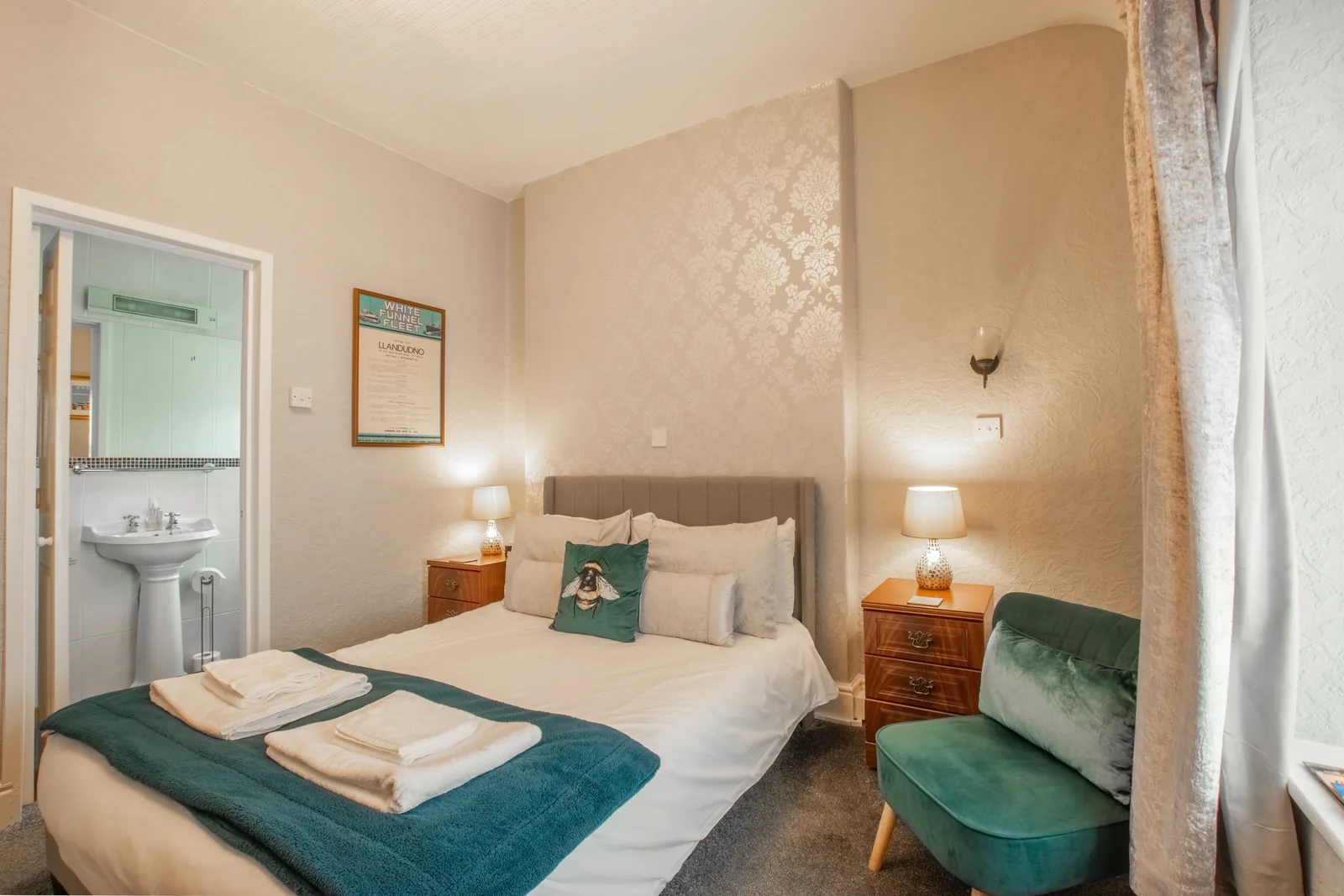 Caernarfon, Room 4: the bed and bedside lamps, with the en-suite door open