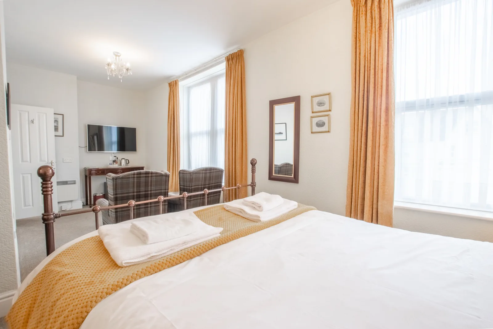 Conwy Studio, Room 6: the bed made up with towels, looking towards the sitting area