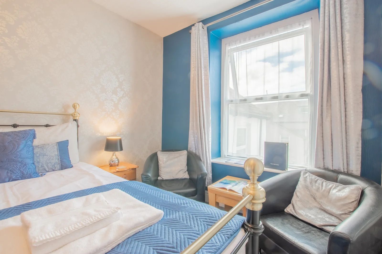 Harlech, Room 7: two leather armchairs by the window, next to the bed