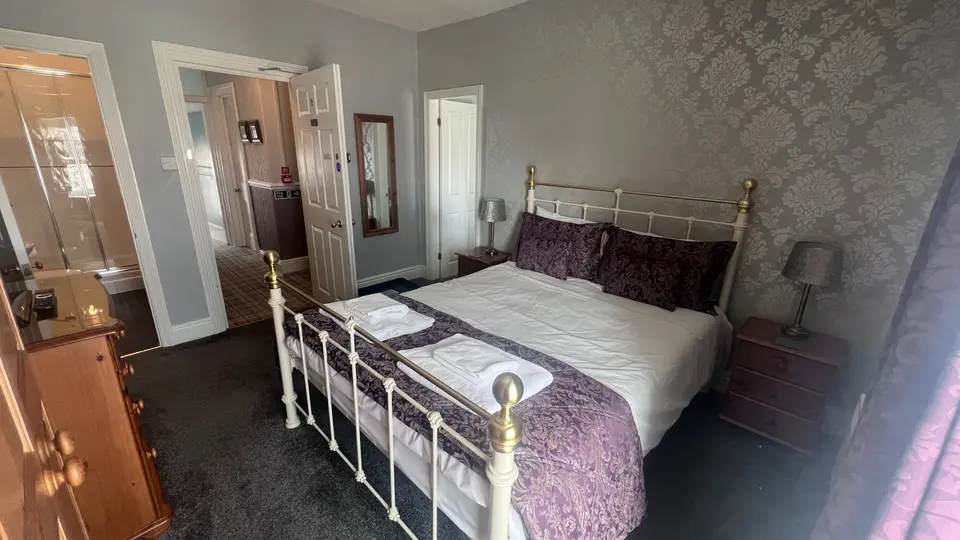 Snowdon Suite, Room 8: a king size bed with a purple throw, and the door through to the landing